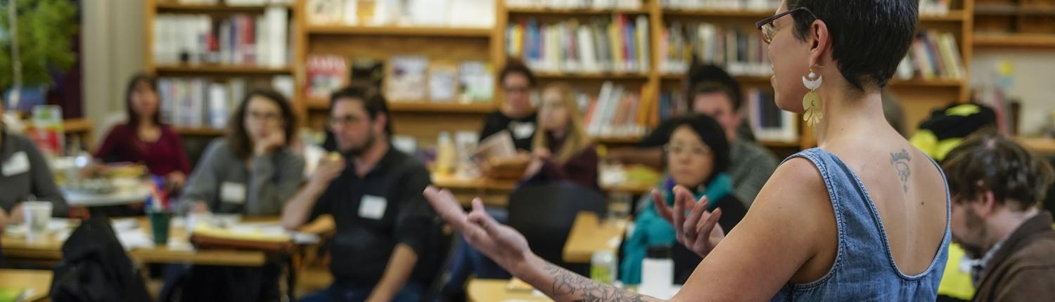 A blurry photo of people sitting in a library.